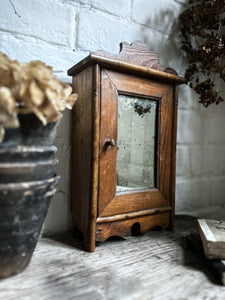 Small French antique wall hung wooden cabinet with shelves foxed glass door mirror