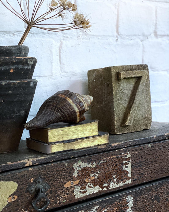 A solid stone reclaimed salvaged vintage carved cube with a 1930's font number 7
