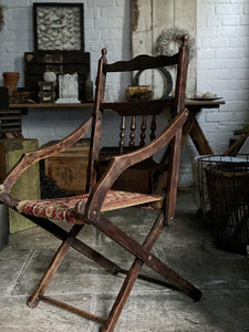 An Antique Victorian wooden frame folding campaign chair with carpet seat