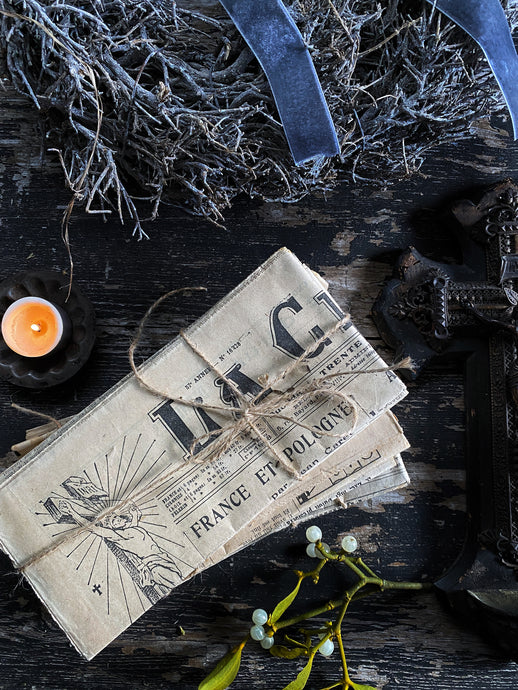 A bundle of French vintage papers tied with string styling props