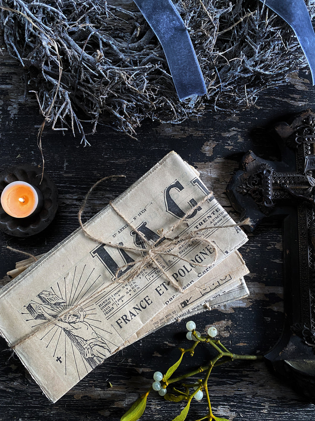 A bundle of French vintage papers tied with string styling props