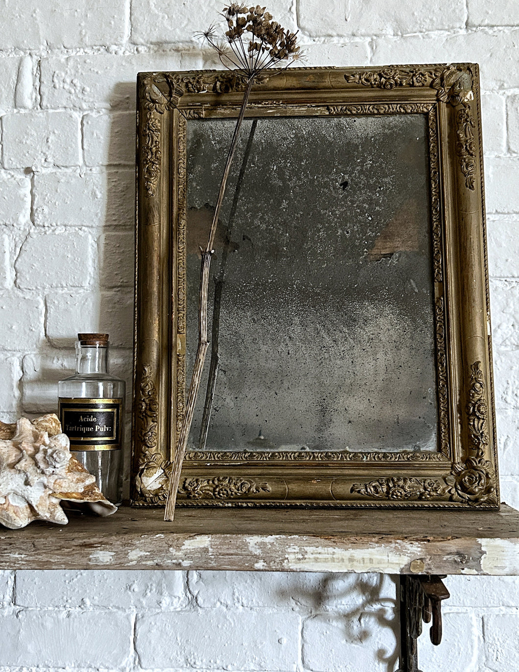 A French Antique plaster gilded gold mirror with foxed distressed plate glass