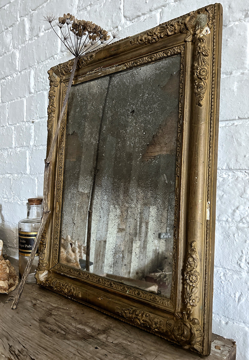 A French Antique plaster gilded gold mirror with foxed distressed plat ...