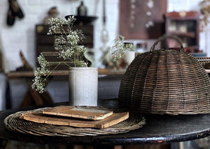 A rustic Vintage French wicker food cloche with tray