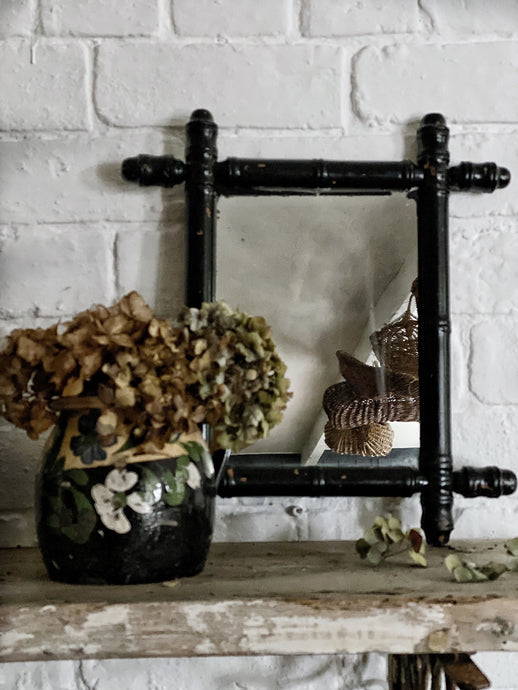A Vintage black painted Oxford Cross Faux bamboo Mirror