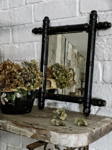 A Vintage black painted Oxford Cross Faux bamboo Mirror