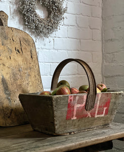 This lovely rustic vintage French wooden trug with a recycled handle made from an old bicycle wheel, which was used by grape harvesters on the vineyards, for collecting grapes.