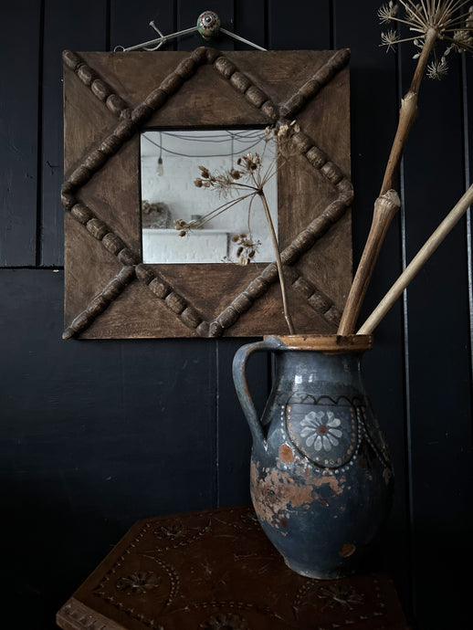 A rustic vintage wooden bobbin detail wall mirror
