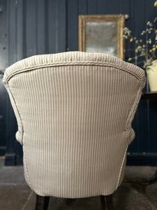 A Victorian Button back antique ticking striped arm chair