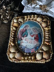 A vintage French religious picture with sailors souvenir shell frame