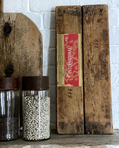 A vintage rustic wooden cigar press with original label on reverse