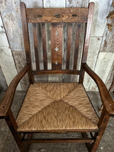 Load image into Gallery viewer, An antique wooden oak carved Arts &amp; Crafts rush seat rocking chair