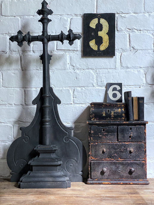 A large decorative black painted wooden French Vintage altar cross