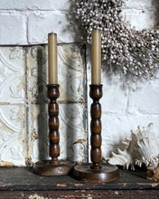 Load image into Gallery viewer, These lovely vintage dark wood turned bobbin style candle sticks