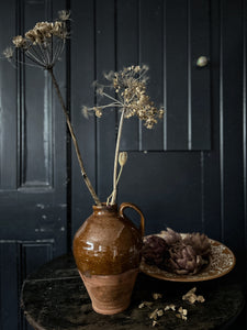 A vintage terracotta farmhouse style jug