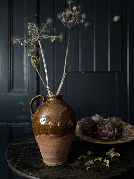 A vintage terracotta farmhouse style jug