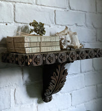 Load image into Gallery viewer, vintage display shelf. Decorative carved from dark wood with beautiful detailing along the edges and a central carved acanthus leaf.
