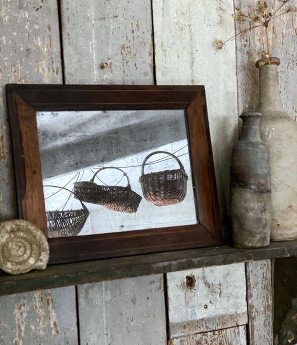 A small antique vintage dark wooden foxed glass plate mirror